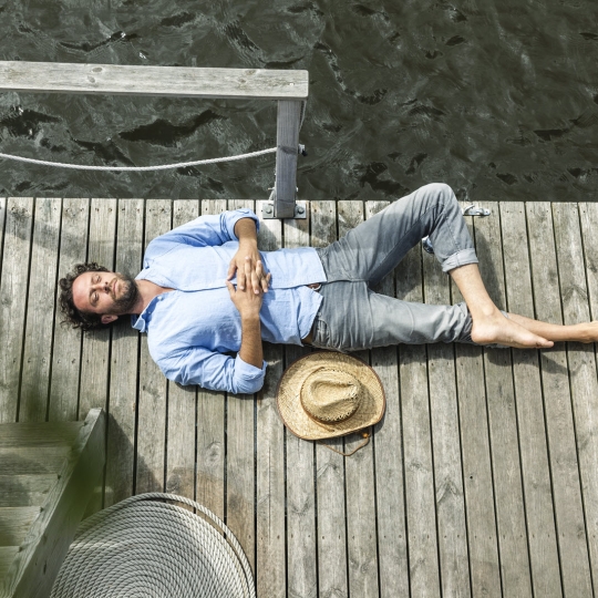 Man relaxing on wharf